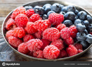 Berry fruits in a bowl blueberries, raspberries. Sweet summer fruits.